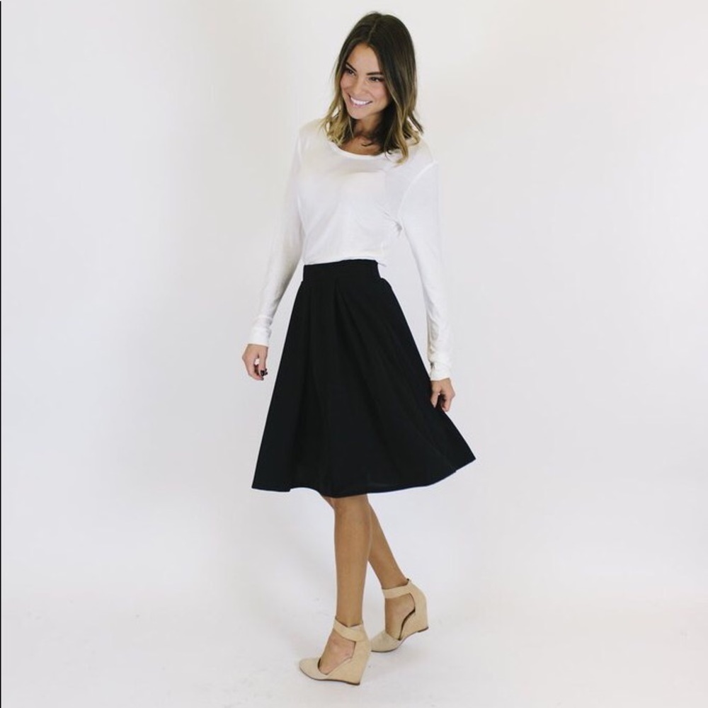 Black pleated knee length skirt